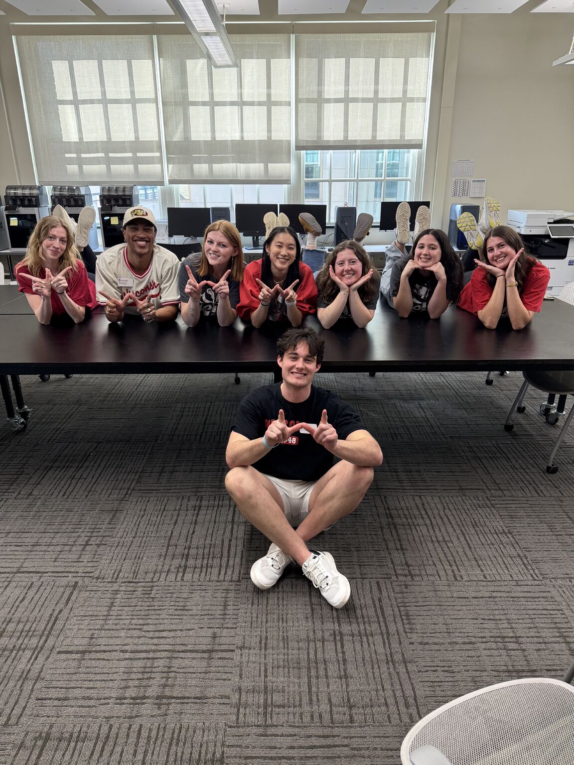 Student ambassadors holding up a W