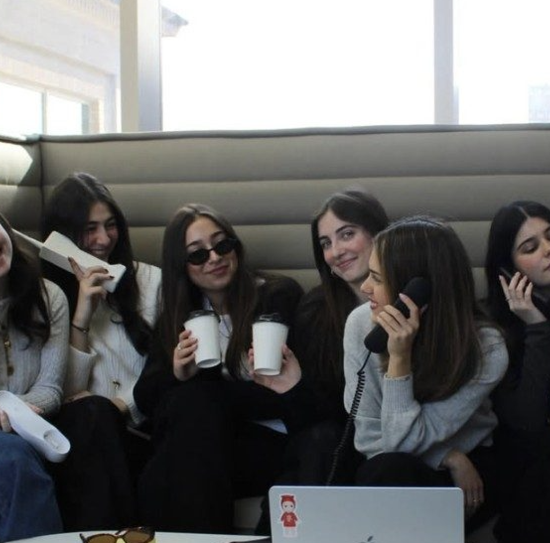 Members of the Madison Fashion Business Collective posing with phones and cups